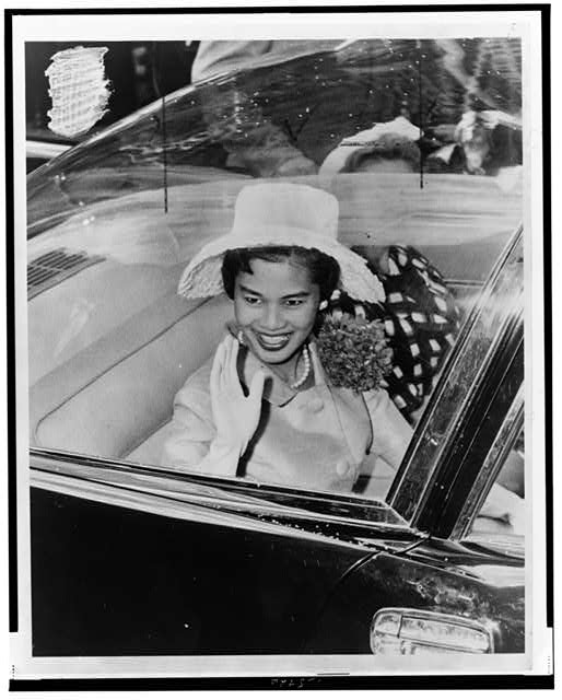 [Queen Sirikit of Thailand, seated in car, waving, probably during ticker tape parade, New York City]