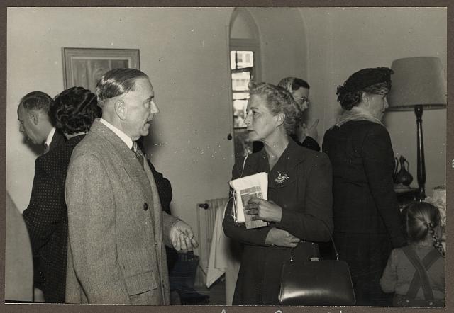 [Mrs. Anna Grace Vester Lind, facing left, listening to unidentified man, at American Colony bazaar, probably in Jerusalem]