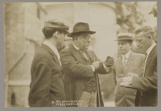 [Theodore Roosevelt speaking with three men, probably reporters]