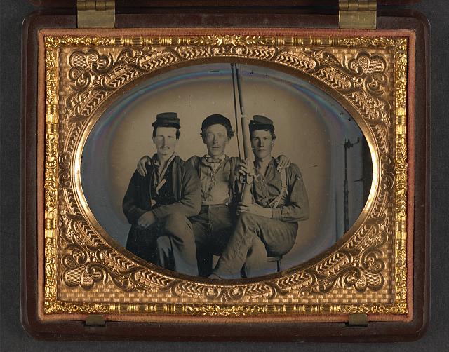 [Three unidentified soldiers in forage caps with musket, probably Union uniforms]