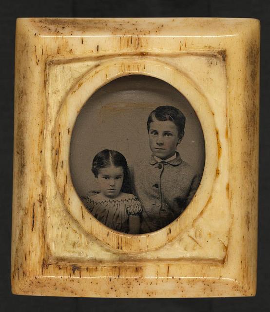 [Unidentified girl and boy, probably siblings, in ring]