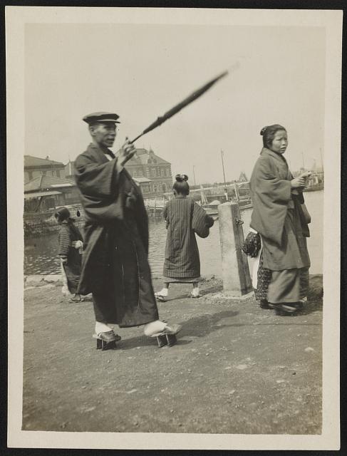 [Man and woman, probably Japanese, wearing geta on their feet]