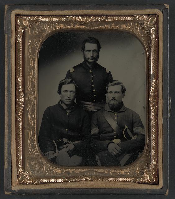 [Three unidentified soldiers, probably of Company B, 23rd Ohio Infantry Regiment, with revolvers and sword]