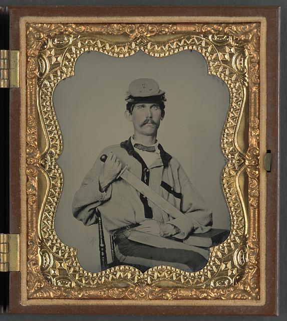 [Soldier in Confederate uniform and Co. D, 3rd North Carolina Volunteers Regiment hat with short sword and sheath with initials J.L.W., probably for Private John L. Wood of Co. D, 3rd North Carolina Infantry Regiment]