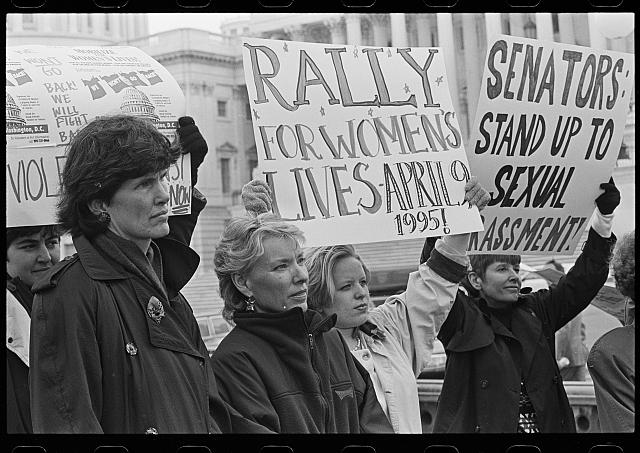 [Women outside the U.S. Capitol holding signs supporting the National Organization for Women's "Rally for Women's Lives" and against sexual harassment, probably in reference to the accusations against Senator Bob Packwood]