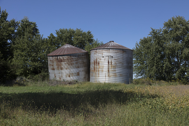 One of these metal silos, and maybe each of them, isn't exactly plumb