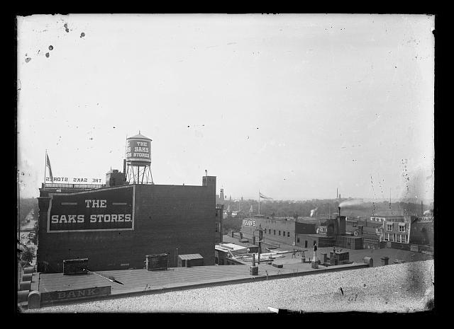 [View looking South to Southwest probably from Jenifer Building, (7th & D, N.W.), towards Center Market, Mall, Castle, Printing & Engraving, and showing the Saks stores, Kanns building, and other rooftops]