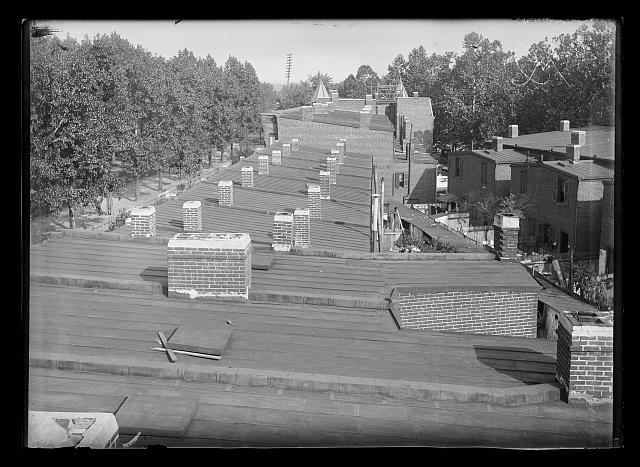 [View of roof tops of neighborhood row houses probably in S.W.]