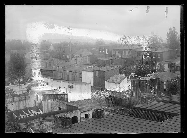 [An elevated view overlooking public housing, old wooden structures and apartments, probably in S.W. neighborhood; Smallwood School? (I between 3rd & 4th, S.W.)]