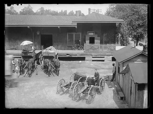 [View of S.W., block 386, probably D Street side of Baltimore & Potomac Railroad Freight Station at Maryland & D, 9th & 10th, showing man loading freight into horse-drawn cart]