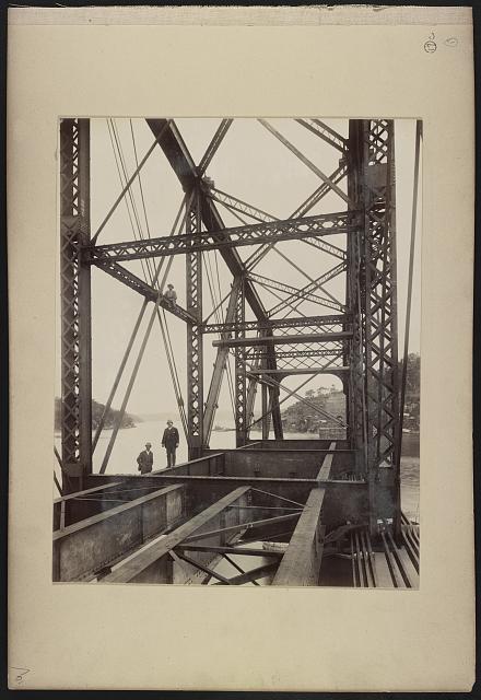 [Newly installed span of Hawkesbury River Railway Bridge, New South Wales, Australia, with men posed on it, probably E.K. Morse and S.V. Ryland]