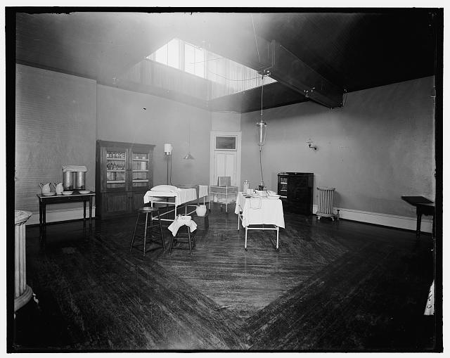 [Room with medicine cabinet, basins, and massage or treatment table, probably the Ypsilanti mine bath house, Ypsilanti, Mich.]