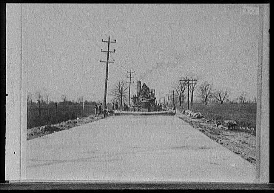 [Steamroller grading road, probably Michigan]