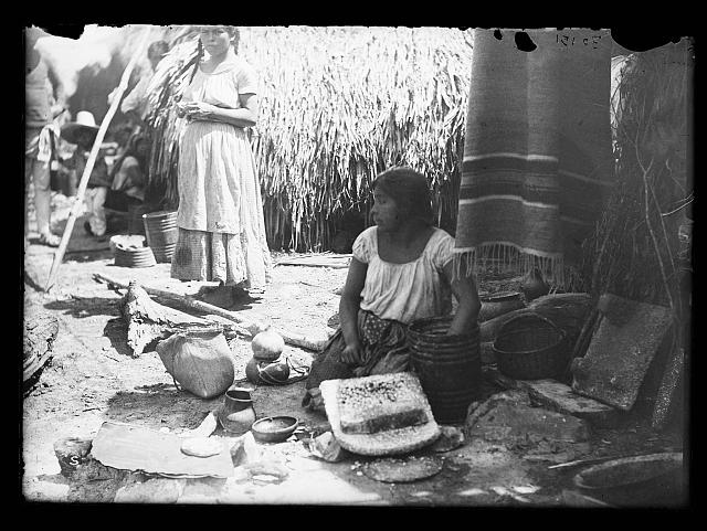 [Woman with pottery at market, probably Mexico]