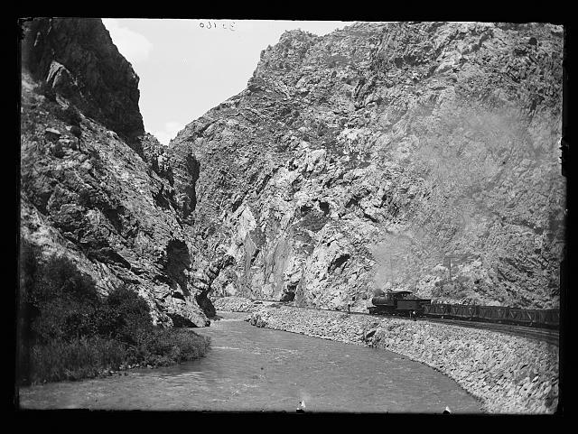 [Train by river in steep canyon, probably Mexico]