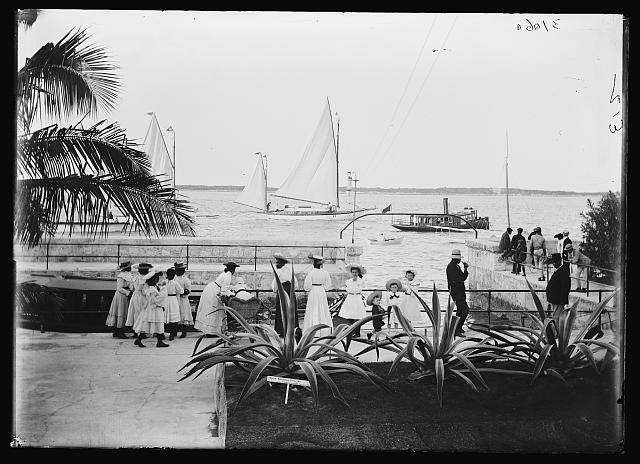 [Girls watching boats at the wharf, possibly Nassau, probably Bahamas]