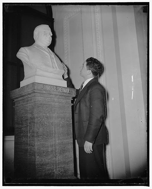 Only bespectacled bust at Capitol. Washington, D.C., March 24. A bust with spectacles is probably not unique but at the U.S. Capitol one is practically a curiosity. It is that of former Vice President Thomas E. Sherman, and, is the only one of a person wearing spectacles of the many standing in the historic structure. Duane Derrick is viewing the bust, 3/24/38