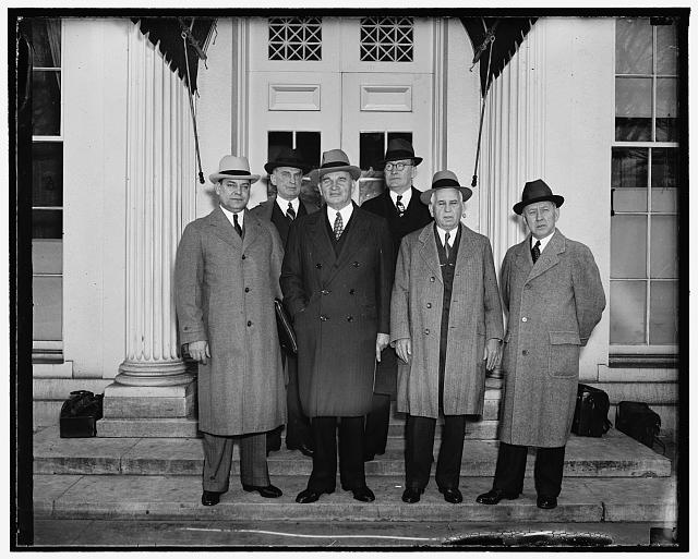 Chief Executive discusses rail problems with R.R. Heads. Washington, D.C., April 4. Following a conference [..] President Roosevelt today, representatives of rail [...] and management indicated the chief executive would probably send a special message on railroad problems to congress sometime this week. From a reliable source, it was learned the president asked the railroads not to out the wages of their nearly 1,000,000 employees. At the same time the railroad men laid before the President Roosevelt a proposal for a federal guarantee of rail income as an effort to revive business and save the industry. In the photograph, left to right: (front row) George Harrison, Chairman of Railroad Labor Association of American Railroads; E.J. Manion, President of Brotherhood of Locomotive Firemen and Enginemen. Back row, left to right: Ernest E. Norris, Vice President of Southern Railway; and S.H. Hogan, President of Marine Engineers, 4/4/38