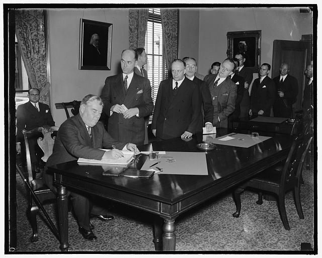 Lawyers sign register at opening of Supreme Court. Washington, D.C., Oct. 3. Probably the largest group of lawyers ever admitted to practice before the Supreme Court were granted this courtesy today as the court convened for the 1938-39 term. From all parts of the country came the barristers who are pictured signing the register following their admittance. John A. Matthews of Newark, N.J., is signing in this picture, 10/3/38