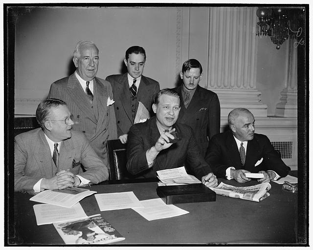 Curtain for Dies Committee. Washington, D.C., Dec. 15. Probably the most criticized congressional investigation in many years came to an end today when Chairman Martin Dies brought down his gavel to signalize the House Committee Investigating Un-American Activities is adjourned. Pictured as the final hearing closed are, left to right, seated: Rep. Harold G. Mosier, Ohio-Chairman Martin Dies. and Rep. J. Parnell Thomas of New Jersey. Standing, left to right: Rep. John J. Dempsey of New Mexico; Ree. Stripling, Secretary to the committee, and John Metcalf, Chief Investigator, 12/18/38