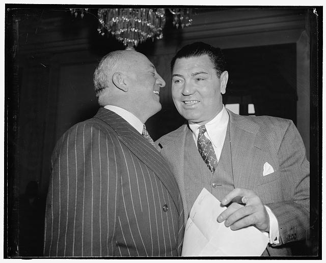 Maybe they discuss Joe Lewis? Washington, D.C., May 25. Col. John R. Kilpatrick, President of the Madison Square Garden Corp., and Jack Dempsey having a whispered conversation before the beginning of today's hearing upon a bill by Sen. W. Warren Barbour to lift the ban upon the shipment of fight films in interstate commerce