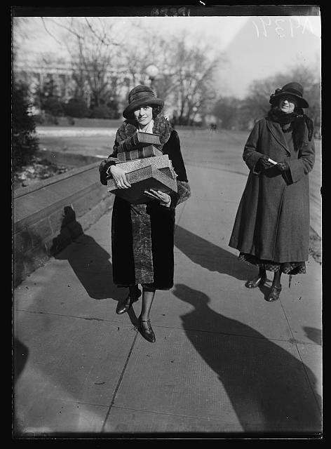 [Woman, probably a suffragist or member of National Woman's Party, walking with an armload of books, Washington, D.C.]