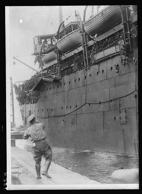 [Soldiers on board ship, probably going to (or arriving in) Europe because they don't have overseas hats]