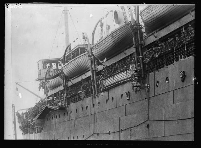 [Soldiers on board ship, probably going to (or arriving in) Europe because they don't have overseas hats]