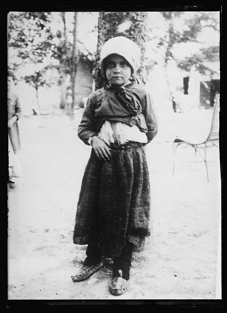 The Little Lady of Sorrow. All the tragedy and woe of Serbia's seven years of war are written on the face and heart of this little Serbian lass of ten years. Her father and mother are dead. Her home is in ashes. Her brothers and sister are scattered, probably dead. Serbia has 300,000 such parentless children and each one of these seems to carry on their little shoulders the full burden of Serbia's sorrow. A place has just been found for this little girl in the American Red Cross orphanage at Vrange, where she will learn to smile again