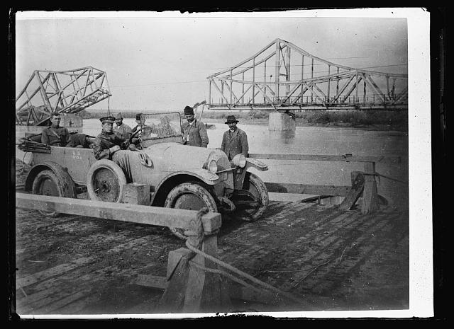How the Austrians Said Farewell. This is the bridge across the Morava River near Pazharevatz, Serbia, that the Austrian Army blew up in its final retreat. Nearly every bridge in Serbia suffered the same fate, and it will probably be years until they are reconstructed. The Serbians have put ferries into operation at the most important crossings and Major G.H. Edwards, of Orlando, Fla. is seen crossing on one of these. Major Edwards is the deputy Commissioner of the Serbian Commission of the American Red Cross, and has been decorated by the Serbian government for his work there