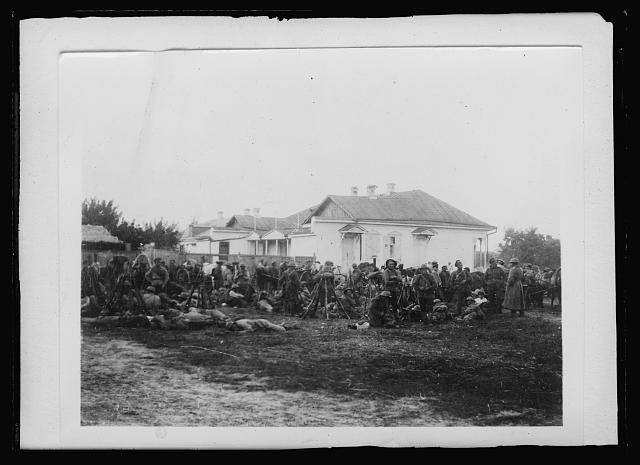 Members of the Korniloff Infantry Regiment in the outskirts of Kharkov. This regiment is named after the remarkable personality, who, if permitted by Karinski, could probably have prevented the downfall of the Duma and the sensational coup of the Bolsheviks in November 1917. General Korniloff pleaded with Karinski for severe measures, and was backed up by the "division savage", which idolized him