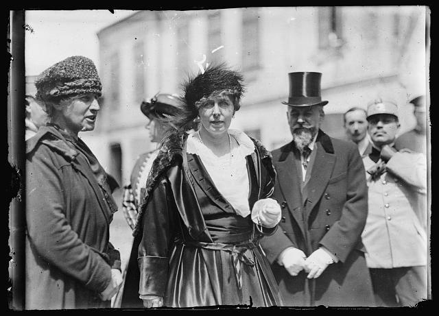 The Queen of queens. This is the title that has been frequently applied to Queen Marie of Roumania, not only because of her renowned beauty but because of her charming manner and democracy. There is probably no ruler in Europe who has the welfare of the people so much at heart as Wueen [sic] Marie. This picture shows her on her way to visit the American Red Cross orphanage in Bucarest. The Queen is a weekly visitor at the institution and the children are always rewarded with candy, toys or cakes when the Queen visits them