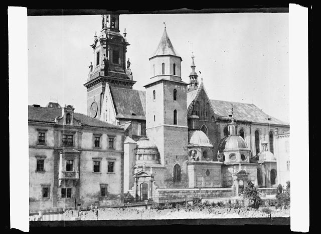 Poland's tribute to America. The old Schloss Tower, there is probably no more famous tower in Eastern Europe than that of the old Schloss, or palace in Cracow, the city which was once the capital of Poland. The tower is on the cathedral enclosed within the palace walls and beside it stands the newer and leftier, but less historic one. Beneath it lie the tombs of all the Polish kings who struggled to maintain the integrity of the country, many having given their lives on the battlefield for their country's cause. Cracow, the capital and the historic tombs of kings passed into Austrian hands with the partition of Poland and has only been rejoined to the mother country since 1918. The cathedral is veritably the shrine of Poland