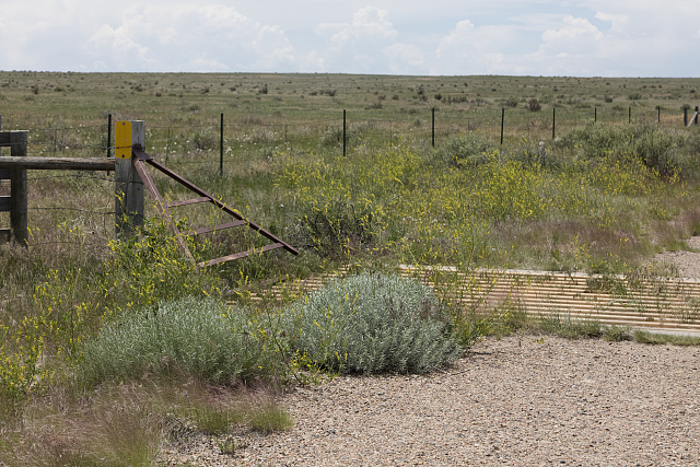 A cattle guard, one of thousands, maybe even millions, in America's cattle country. This one is is Otero County, Colorado. Simply, a cattle guard is a series of metal tubes or bars, spaced a few inches apart and secured over a ditch