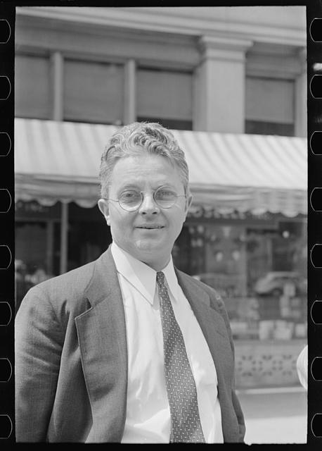 [Roy E. Stryker, photograph chief of the U.S. Farm Security Administration standing in street, probably in Washington, D.C.]
