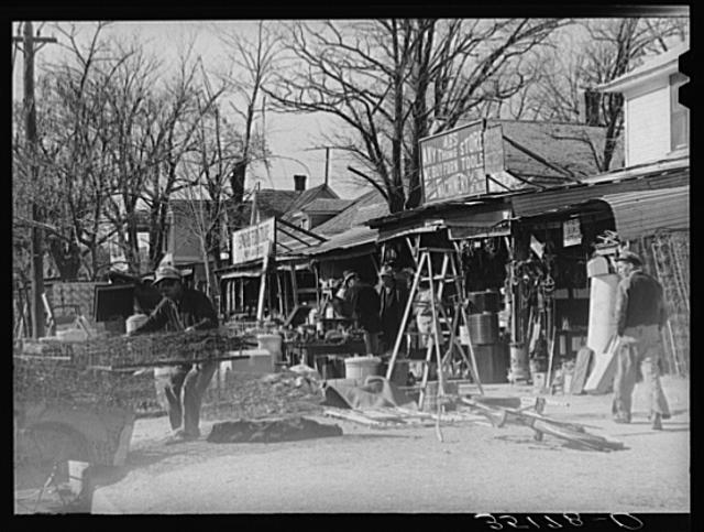 Secondhand row, Oklahoma City, Oklahoma. Oklahoma City seems to have an unusually large number of these cheap secondhand stores, probably because of the floating oil workers and currently shifting populations in surrounding rural areas