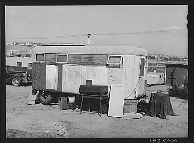 Trailer in trailer court. This trailer is obviously unmovable and because this court is assuming the characteristics of a shack town and because the sanitary facilities are inadequate, it will probably be condemned by board of health. San Diego, California