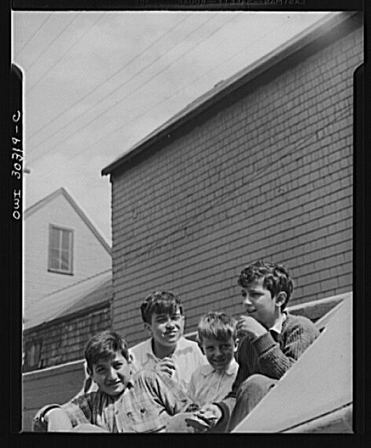 Gloucester, Massachusetts. Boys who hang around the fishing docks who probably hope to go to sea as fishermen themselves someday