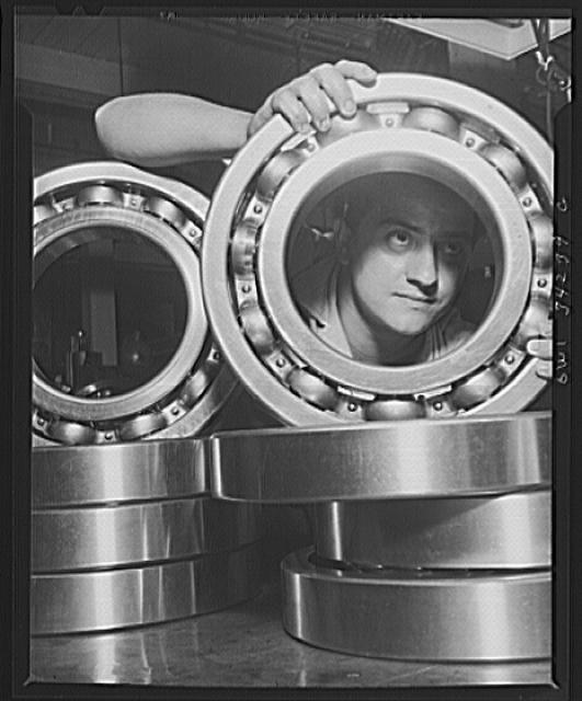 New Britain, Connecticut. An inspector at the Fafnir Bearing Company inspecting large roller bearing which will probably end up in an Army tank