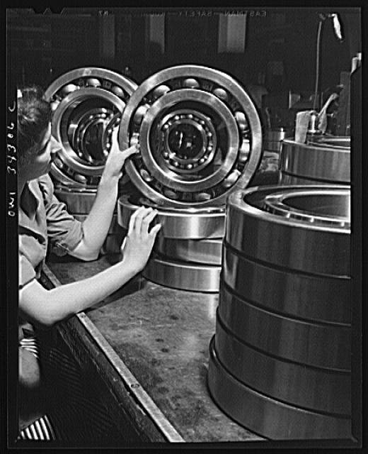 New Britain, Connecticut. An inspector at the Fafnir Bearing Company inspecting large roller bearing which will probably end up in an Army tank