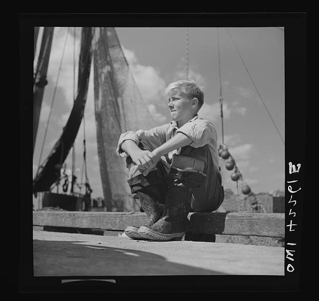 Gloucester, Massachusetts. A young boy, probably a fisherman of tomorrow, because many of the boys will follow their fathers as fishermen in the New England waters