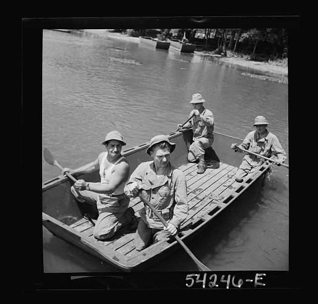 Fort Belvoir, Virginia. Four soldiers of the United States Army Engineer Corps paddling a barge, probably for the construction of a bridge