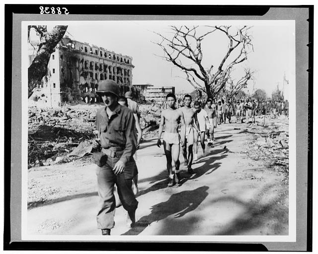 Japanese prisoners of war being guarded by Americans--probably in the Philippines