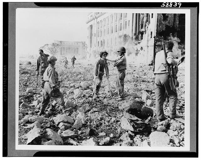 Japanese prisoners of war being guarded by Americans--probably in the Philippines
