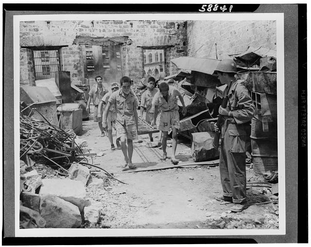 Japanese prisoners of war being guarded by Americans--probably in the Philippines