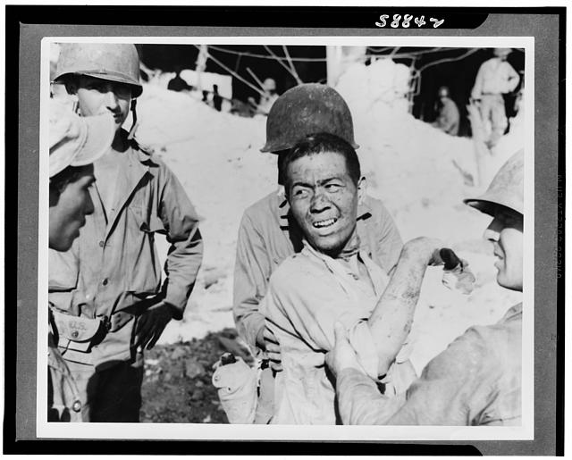 Japanese prisoners of war being guarded by Americans--probably in the Philippines