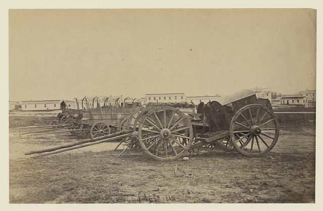 [Wagons with caisson in foreground, probably at a Civil War military camp]