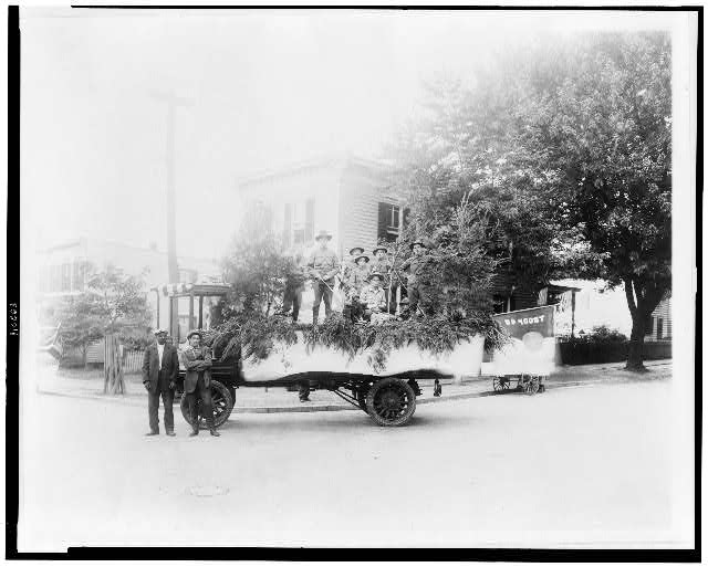 [Boy Scouts posed with a truck decorated for a parade, probably in the Anacostia section of Washington, D.C.]
