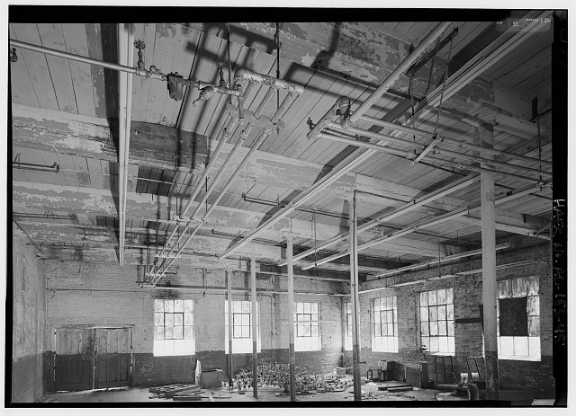 45.  1915 CLOTH ROOM ADJACENT TO PICKER ROOM, SECOND FLOOR, NORTH END OF MILL NO. 2, WALL ON LEFT DIVIDING CLOTH ROOM ADDED LATER (PROBABLY C. 1970s). - Prattville Manufacturing Company, Number One, 242 South Court Street, Prattville, Autauga County, AL