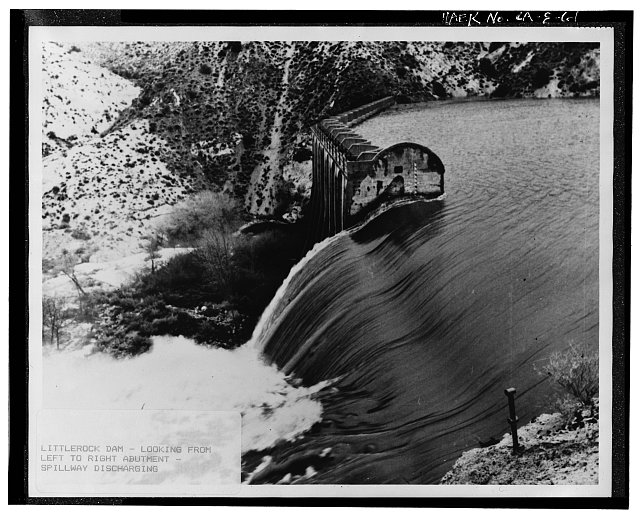 61.  'LITTLEROCK DAM - LOOKING FROM LEFT TO RIGHT ABUTMENT-SPILLWAY DISCHARGING.' No date; probably 1960s. Photographer unknown. - Little Rock Creek Dam, Little Rock Creek, Littlerock, Los Angeles County, CA